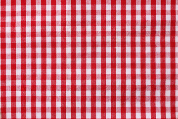 Red checkered tablecloth as background, top view