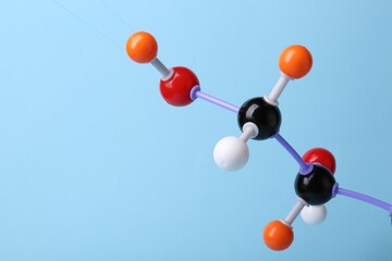 Molecule of sugar on light blue background, closeup and space for text. Chemical model