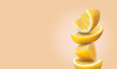 Stack of cut fresh lemons on pale coral background, space for text