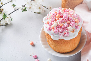 Traditional Easter sweet bread or cakes with white icing and sugar decor, colored eggs and cherry...