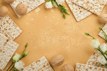 Matzah Passover celebration concept. Traditional ritual Jewish bread on sand color old wall...