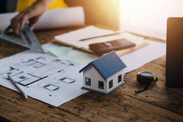 Construction and structure concept of engineer working drawing on blueprint meeting for project working with partner on model building and engineering tools in working site, construction concept
