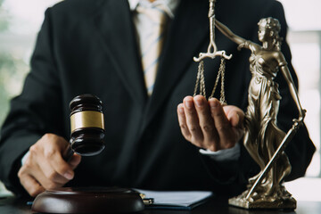 Judge gavel with Justice lawyers having team meeting at law firm background. Concepts of Law and Legal services.