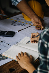 Construction and structure concept of engineer working drawing on blueprint meeting for project working with partner on model building and engineering tools in working site, construction concept