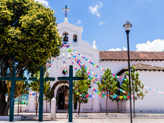 Iconic San Lorenzo church with colorful prayer flags and three christian crosses into its parvis , Zinacantan, Chiapas, Mexico
- 587969375