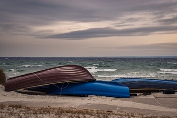 Winter cloudy seaside landscape. Boats on the shores of the Baltic Sea. Photo taken in Gdynia,...