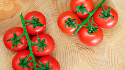 tomatoes with a twig on a wooden background