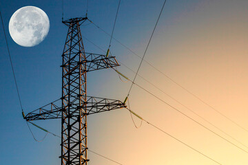 Power line support with wires for electricity transmission. High voltage grid tower and big moon. Energy industry,