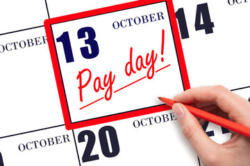 Hand writing text PAY DATE on calendar date October 13 and underline it. Payment due date