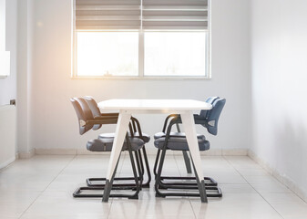 White meeting table front of window in meeting room