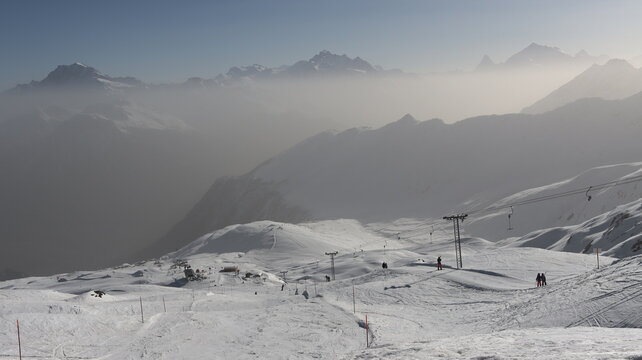 Foggy, clear and beautiful Blatten/Belalp ski area near Brig with drag lift and piste in the foreground