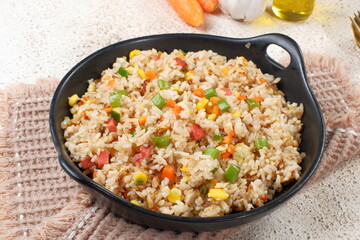 Fried rice with vegetables in a plate, Asian food