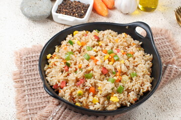 Fried rice with vegetables in a plate, Asian food	