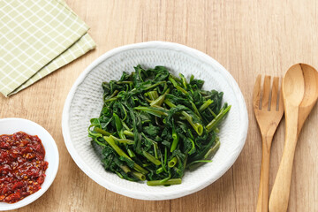 Plecing Kangkung or Brambang Asem, made from boiled spinach served with chili sauce (sambal), spicy and sour. Indonesian food
