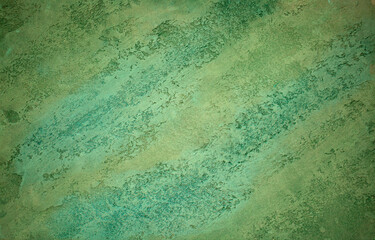 Green background from decorative plaster with abstract spots. Unusual green wall texture with beautiful patterns, creative surface background. Front covering for facing of buildings.