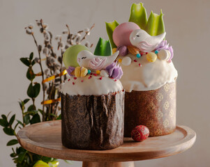 Easter cake with raisins and white fondant with birds and macaroons. on a light background with...