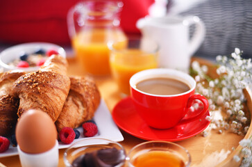 A tray with breakfast on a bed in a hotel room