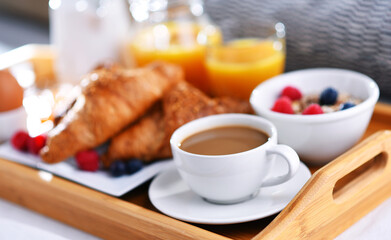 A tray with breakfast on a bed in a hotel room