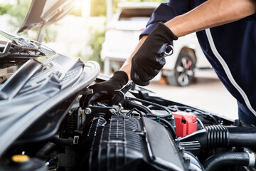 Automobile mechanic repairman hands repairing a car engine automotive workshop with a wrench, car service and maintenance , Repair service