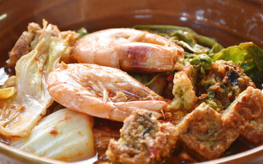 boiled shrimp and fried egg stuffed climbing wattle vegetable in spicy sour soup on bowl