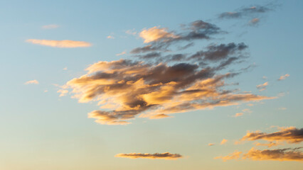 Clouds at sunset. Beautiful sky and clouds at sunset with yellow and azure blue tones. sunset nature sky and clouds backgrounds with wonderful colors. Sky in the background at twilight
