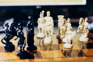 Chess pieces are on the board. The queen and king in chess are in a difficult situation