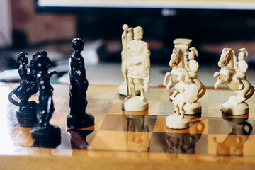 Chess pieces are on the board. The queen and king in chess are in a difficult situation