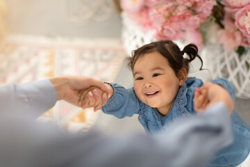 Happy Baby Daughter Holding Hands With Mom Spinning Playing Indoor
