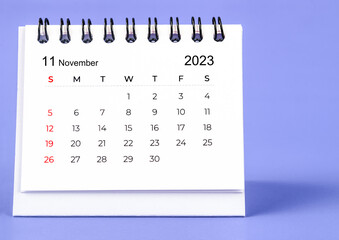 The November 2023 Monthly desk calendar for 2023 year on purple background.