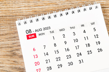 The August 2023 desk calendar for 2023 on wooden background.