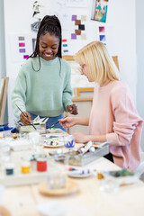 Young female artists working in their painting studio
