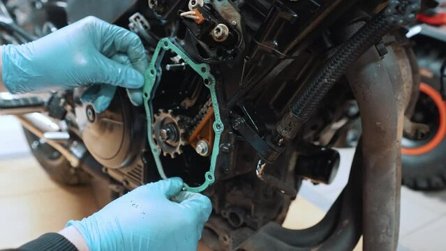 Close up, placing False neutral eliminator kit on the motorcycle transmission box. High quality 4k footage