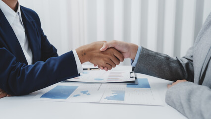 Shaking hands, Young Asia female leader business woman coaching new smes bookkeeping audit accounting interview with trainer training business job.