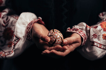 Ukrainian woman hand painted Easter egg. Geometric slavic decoration ornaments
