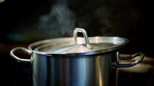 Boiling water steel pan . Steam boil water