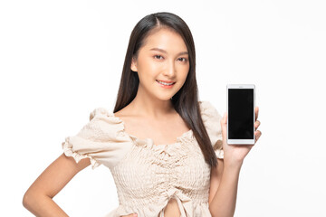 Happy attractive asian young woman smile and showing mobile phone isolated on white background....