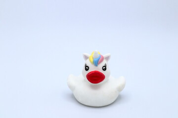 Tiny plastic unicorn duck. Close up and isolated.