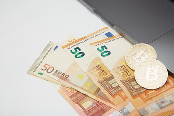 euro and bitcoin banknotes, cryptocurrency and blockchain concept on white background flat lay