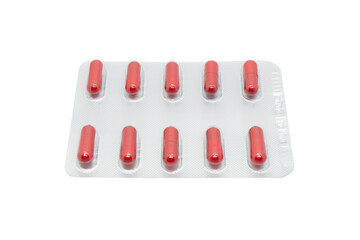 Macro shot pile of red tablets pill in silver blister packaging isolated on white background. Aluminium foil blister pack. Pharmacy products. Medicine pills and drugs. Pills background