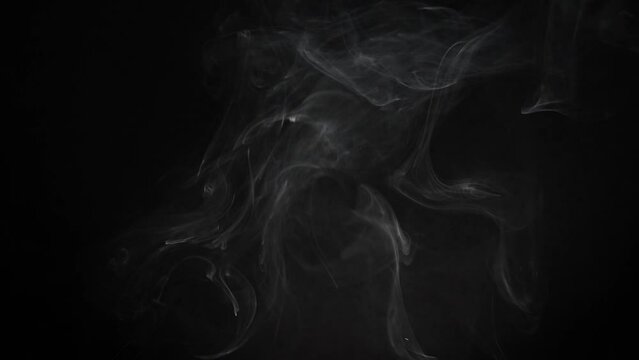 Smoke on a black background. Rising smoke