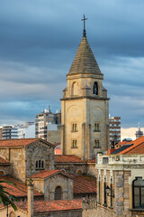 Fototapeta na wymiar Tower old church of San Pedro in the tourist town of Gijon at sunset, Asturias.