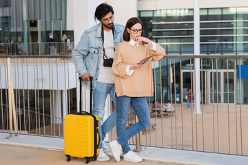 Despaired pensive young multiracial couple in casual and glasses with passport, tickets and...