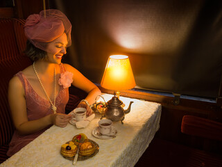 Flapper dress 1920 lady having tea in train