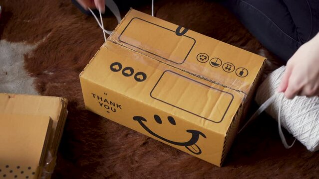 Seller closes the box and sticks a clear scotch tape. Take the white rope and tie the box. Wrap the whole box with twine and tie it tight again. to prevent damage during transportation