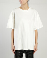 A woman wears a white over size t shirt