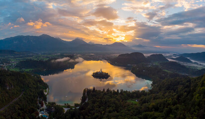 Aerial view of Cerkev Marijinega, a Catholic Church on a small island in the middle of Bled Lake at sunrise, Upper Carniola, Julian Alps, Slovenia.