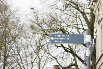 Pole with a blue signpost in the center of Breda in the Netherlands