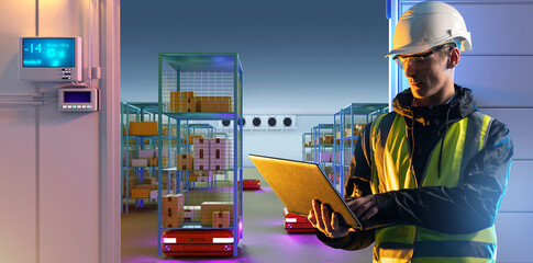 Man engineer with laptop. Freezer in industrial plant. Refrigerated warehouse with robots....
