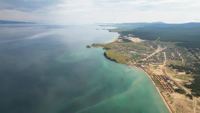 Aerial view of Lake Baikal, Olkhon Island in the village of Khuzhir on a windless summer day. A popular tourist destination for vacations and travel. 4k footage