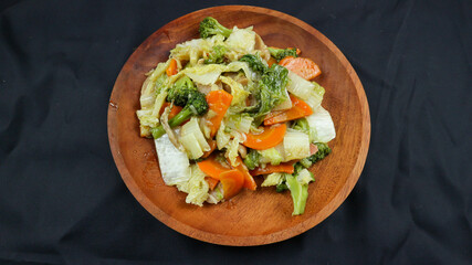 Fried capcay or cap cai or Hokkien is a mixture of vegetables stir-fried with chicken & other dishes. Isolated on black background.